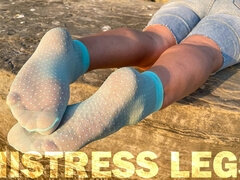 Sexy Soles in Cute Turquoise Nylon Socks on the Seashore at Sunset