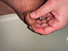 Pissing, playing with my little foreskin dick