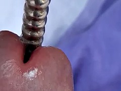 Sounding with a load of cum close-up through a penis plug