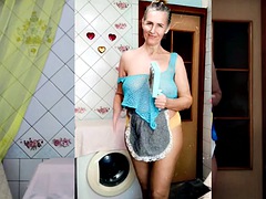 Perky Lukerya, as usual, is engaged in erotic cleaning in a transparent mesh on big hanging tits in yellow panties.