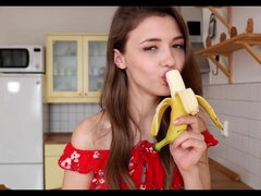 Young brunette girl next door plays with banana in kitchen - solo masturbation