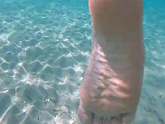 Underwater sex with footjob and nipple squeeze POV on a public beach