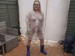 Naked Under Plastic Transparent Raincoat and Wellingtons Out in the Cold Outdoors
