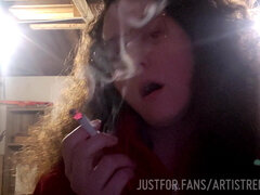 Curly haired brunette lovingly blows smoke in your face