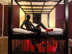 Rubber Nights: the Rubber Slave Rests Tight in a Cage Under the Bed