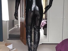 Latex Sissy Doll zipping up her thigh high boots and showing them off