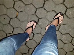 Sexy shemale shows off her amazing feet in platform flip flops on a night walk