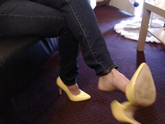 Double crossed yellow pumps dangling