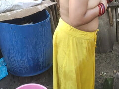 Indian woman bathing outside