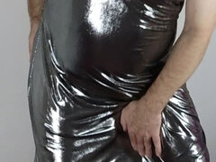 Crossdresser in a full-length metallic shiny silver ballgown
