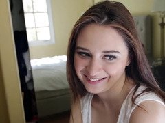 A good-looking babe with a sexy face is riding a big pecker on the bed