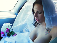 A woman gets penetrated in her wedding gown on the bed