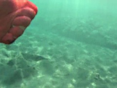 Red stocking in the sea on a public beach