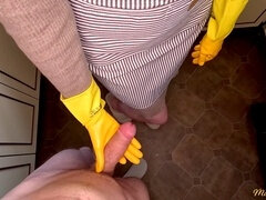 Naughty housewife in apron and gloves gets hot and gives an intense hand job