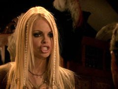 Two girls with serious looks in their faces are in a threesome