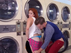 Naughty boy stretches curvy redhead in empty laundromat