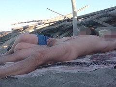 Exhibitionist wife Miss Creamy gives a handjob to a big cock on a nude beach in front of strangers